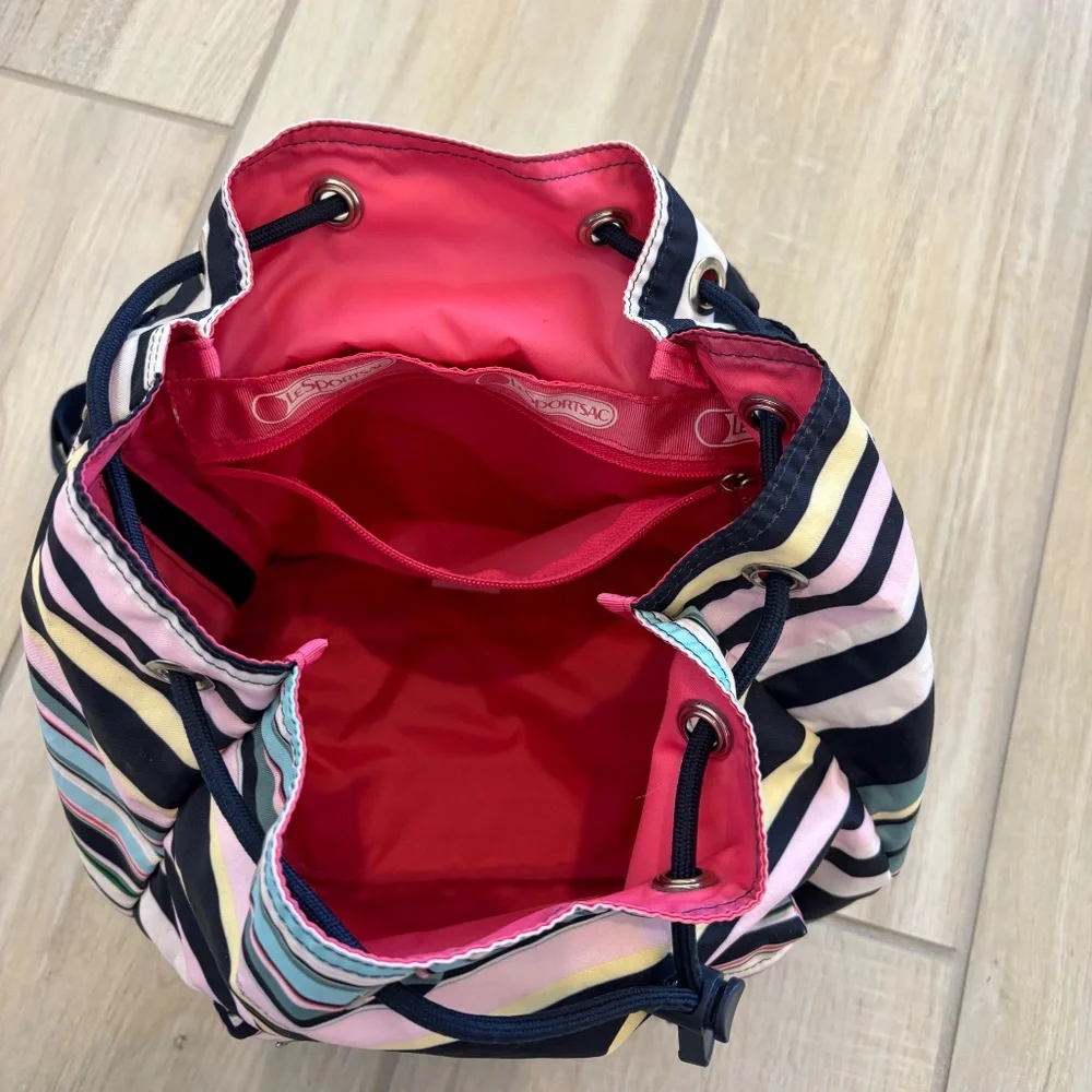 LeSportsac Voyager drawstring backpack in a navy pastel stripe pattern.